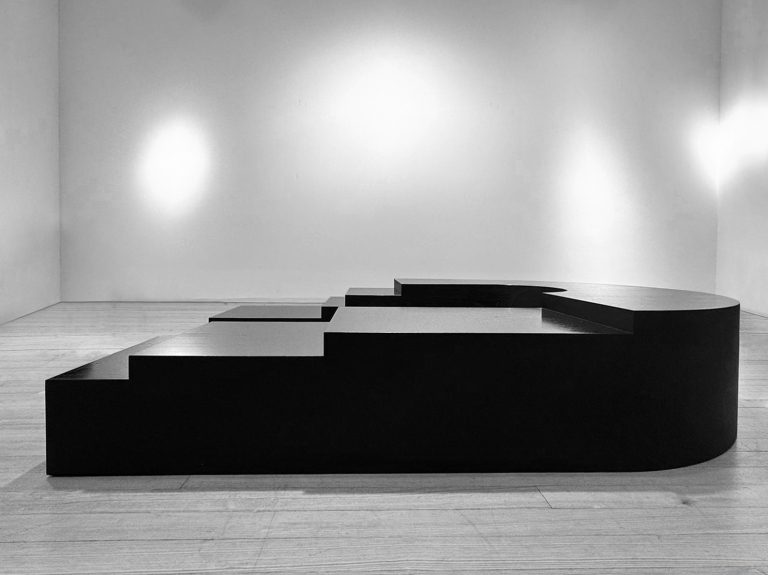 K2505 low sculptural table in ebonized laminated wood by Isac Elam Kaid, a monolithic collectible design object with stepped geometric planes.