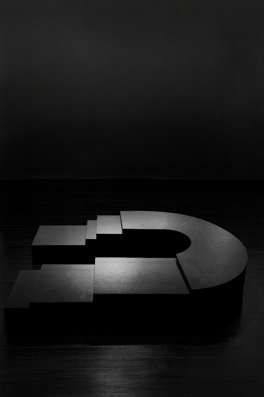 K2505 sculptural ebonized wood table by Isac Elam Kaid, a monolithic low table composed of laminated timber layers forming a stepped architectural mass.