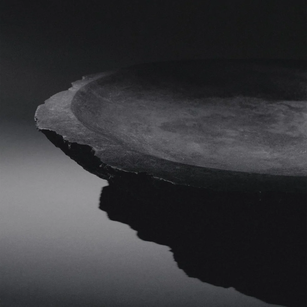 Collectible sculptural bronze vessel artifact by Isac Elam Kaid with irregular broken rim and polished interior basin.