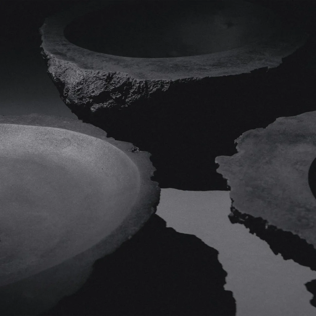 K25-2203 sculptural bronze vessel artifact by Isac Elam Kaid with fractured irregular rim and smooth basin interior.